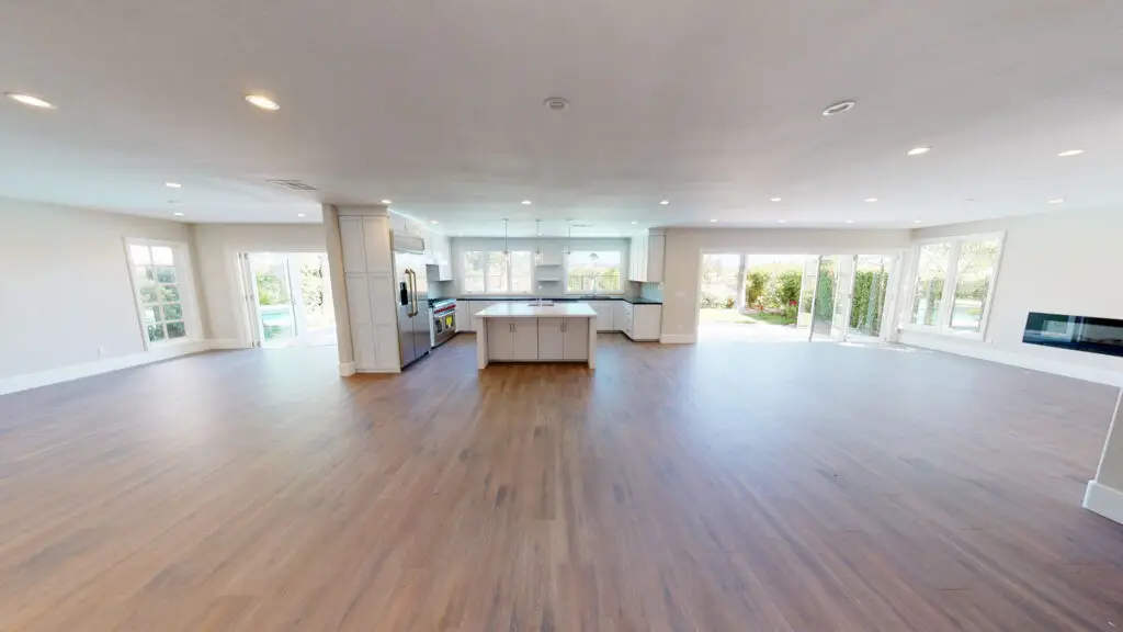 Home remodeling contractor completing an open concept remodel in Orange County, creating a spacious layout that connects the kitchen, dining, and living areas.