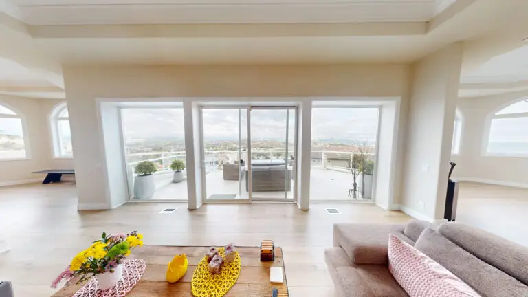 Bright room addition featuring floor-to-ceiling glass doors, expansive patio access, and breathtaking panoramic views of the surrounding landscape.