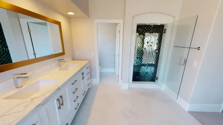 Bathroom from a whole house remodel with a dual vanity and walk-in glass shower
