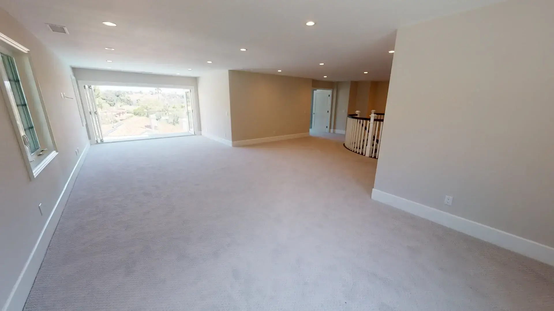 Finished loft space with a panoramic folding door opening to a balcony, part of a whole house remodel