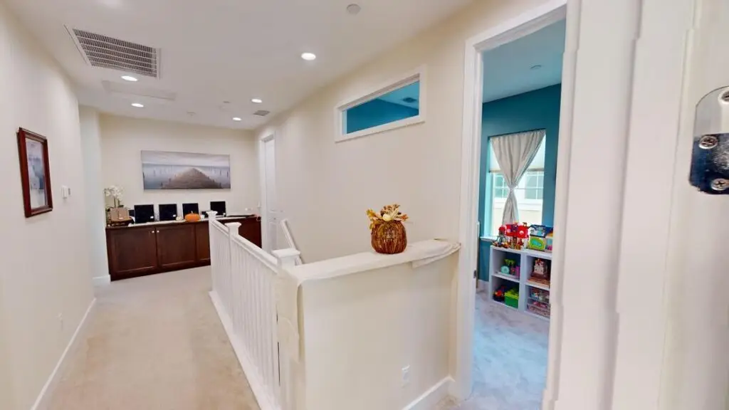 New hallway layout with added room entrance and upgraded finishes in an Orange County home, after second-story room addition