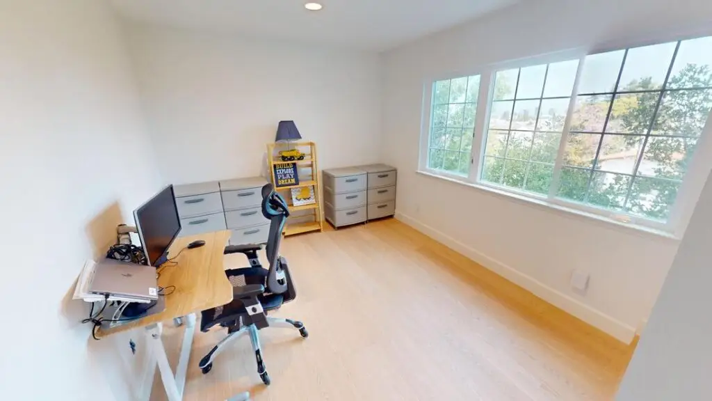 Home remodeling contractor completing a loft addition and high ceiling conversion in Orange County, creating a functional workspace from unused vertical space.