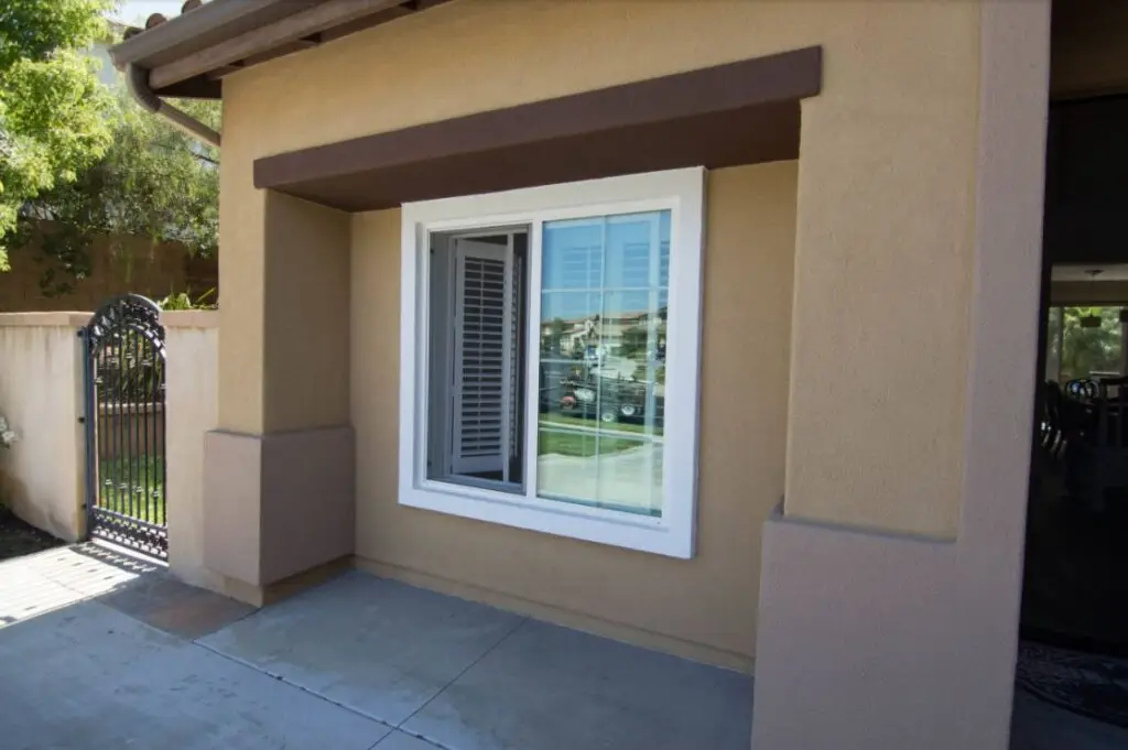 Close-up view of garage conversion featuring a new dual-pane window and stucco exterior seamlessly matching the home’s design
