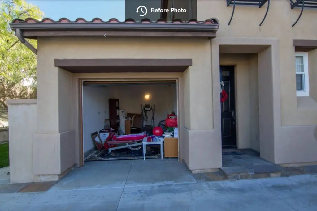Unconverted garage space filled with miscellaneous items before renovation into a livable room