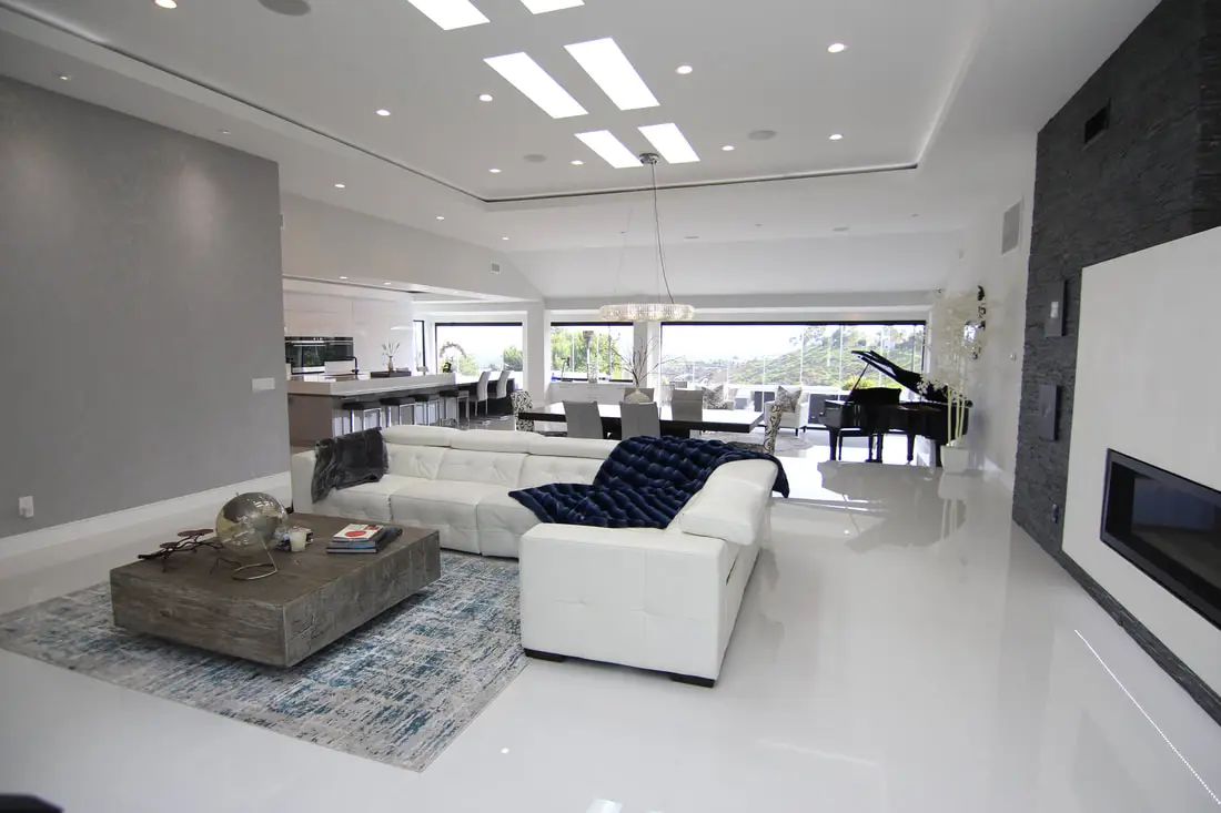 Spacious open-concept living area completed by a high ceiling conversion contractor, showcasing tall ceilings, modern finishes, and abundant natural light.