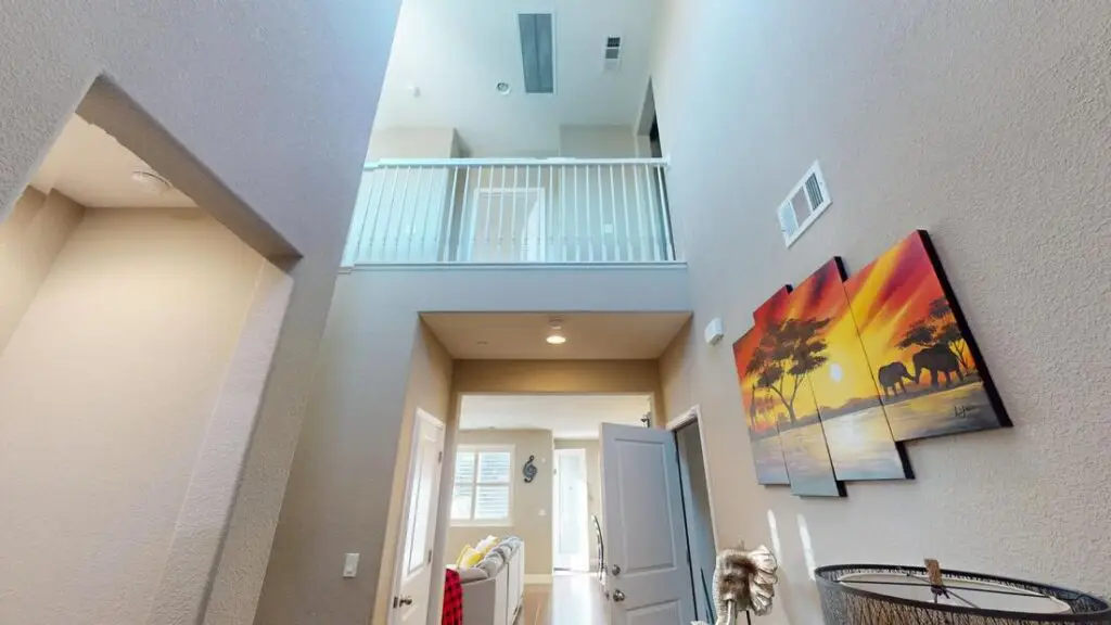 Two-story entry in a Rocklin home before the loft conversion, with a railing overlooking the space from the hallway above