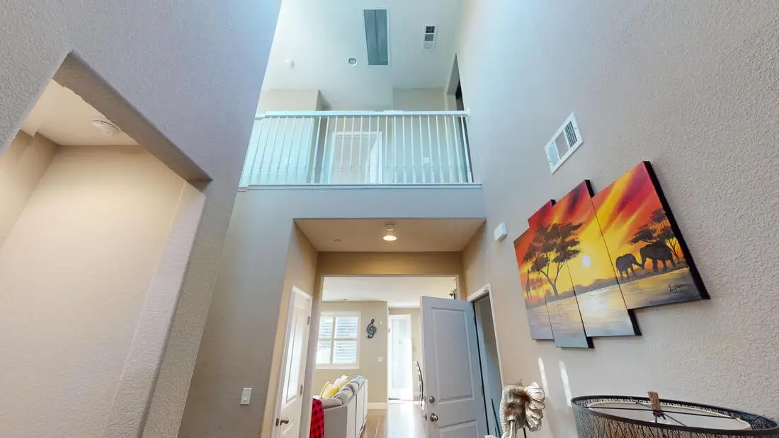 Two-story entry in a Rocklin home before the loft conversion, with a railing overlooking the space from the hallway above